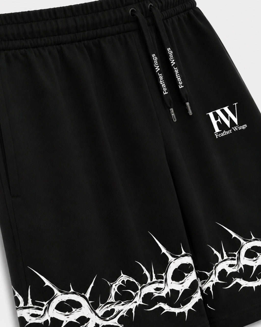 Black athletic shorts with a white thorny graphic print along the hem, a white 'FW' logo on the left thigh, and a black drawstring with white text.