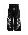 Black wide-leg sweatpants with white tribal-style graphic prints on both legs and a black drawstring waist, shown against a plain white background.